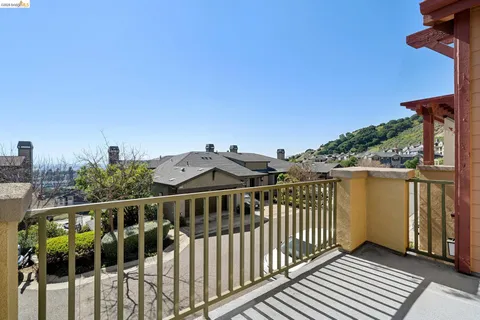 a view of a balcony with wooden floor and fence