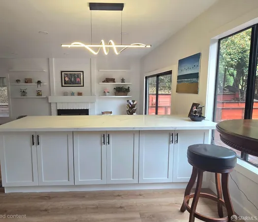 a kitchen with a sink and wooden floor