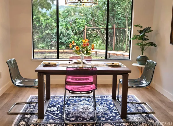 a kitchen with a dining table and chairs