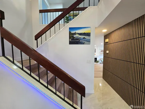 a kitchen with sink wooden floor dining table and chairs