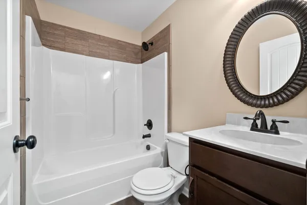 a bathroom with a sink a toilet and a mirror