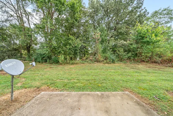 a view of a house with a yard and sitting area