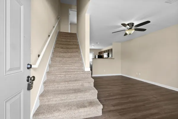 a view of entryway and hall with wooden floor