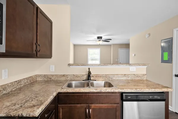a kitchen with granite countertop a sink and cabinets