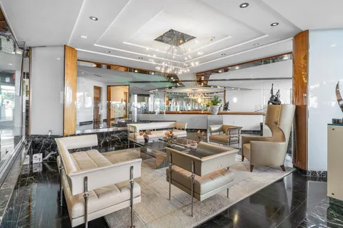 a living room with lots of furniture and kitchen view