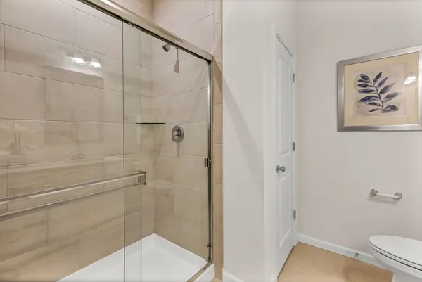 a bathroom with a shower and a toilet