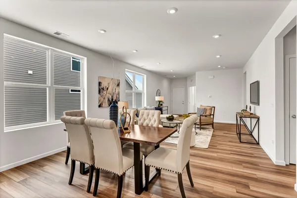 a view of a dining room with furniture window and wooden floor