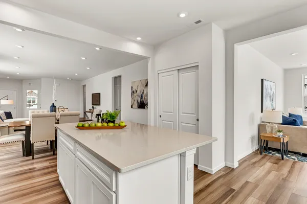 a kitchen with a stove a refrigerator and a table