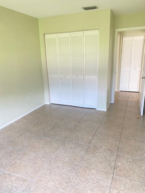 21150 Gertrude Avenue, Unit R1 Port Charlotte, FL 33952 - Photo 12 of 18 an empty room with a natural light