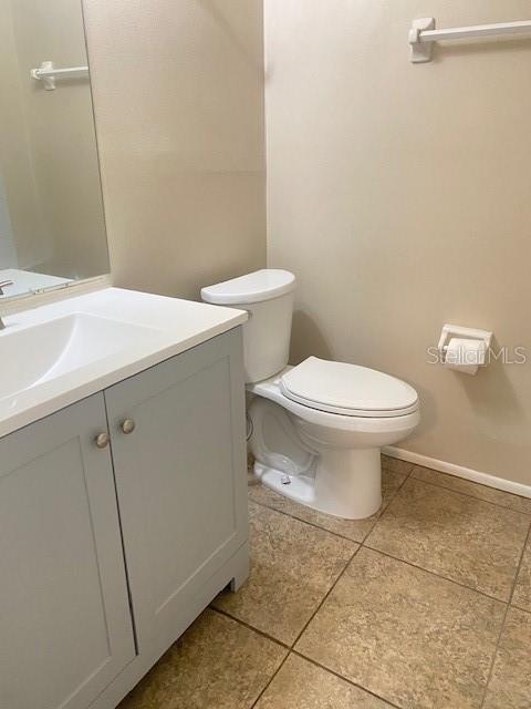 21150 Gertrude Avenue, Unit R1 Port Charlotte, FL 33952 - Photo 13 of 18 a bathroom with a toilet sink and mirror