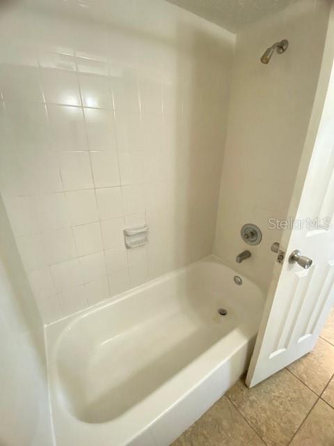 21150 Gertrude Avenue, Unit R1 Port Charlotte, FL 33952 - Photo 14 of 18 a white bath tub sitting next to a shower