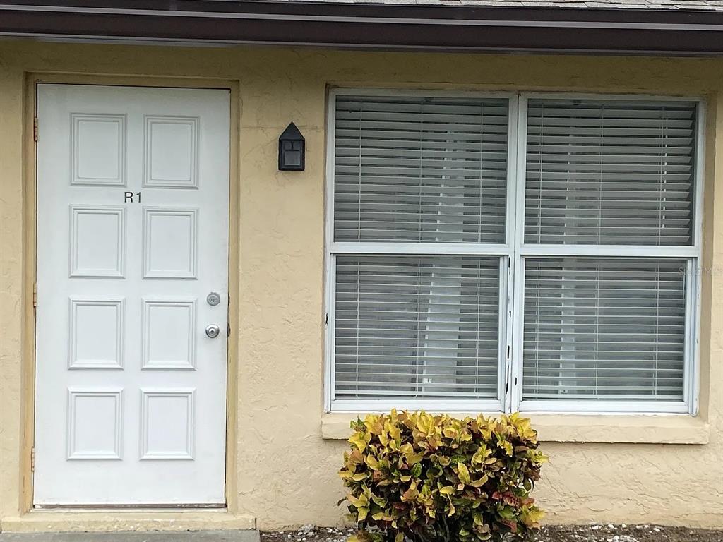 21150 Gertrude Avenue, Unit R1 Port Charlotte, FL 33952 - Photo 3 of 18 a view of a door and a window