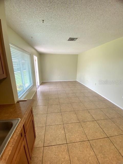 21150 Gertrude Avenue, Unit R1 Port Charlotte, FL 33952 - Photo 5 of 18 a view of an empty room and a window