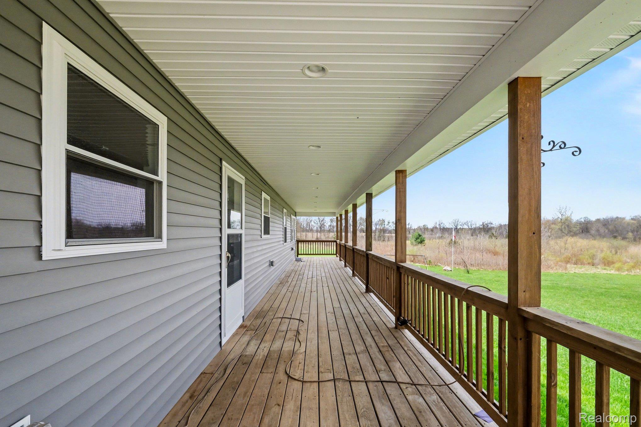 2800 Meadowdale Road Metamora, MI 48455 - Photo 4 of 28 Wooden terrace with a lawn