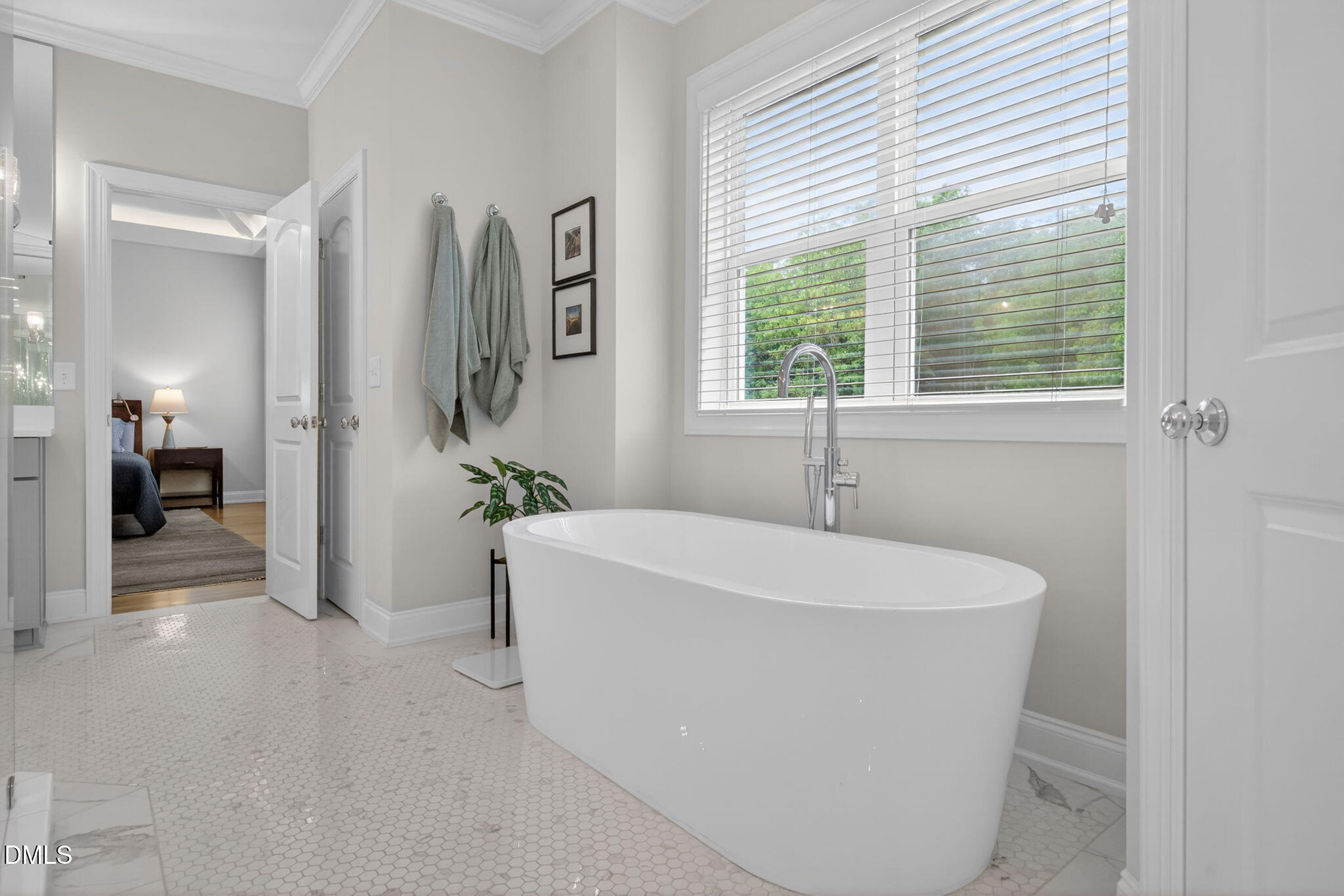 6901 Ray Family Farm Court Raleigh, NC 27613 - Photo 28 of 52 a white bath tub sitting in a bathroom next to a window