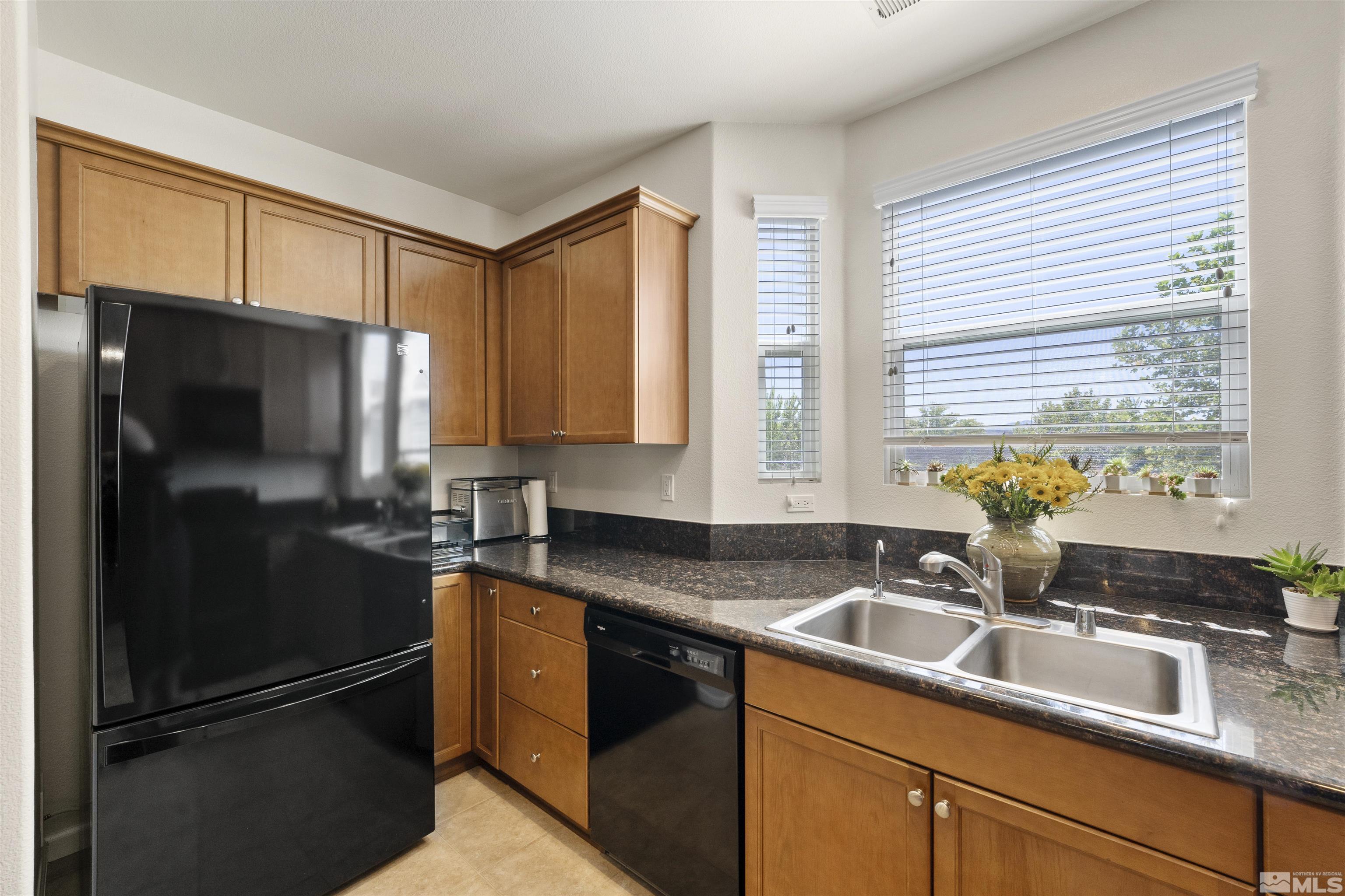 2212 Grosvenor Reno, NV 89509 - Photo 17 of 36 a kitchen with granite countertop stainless steel appliances a refrigerator sink and microwave
