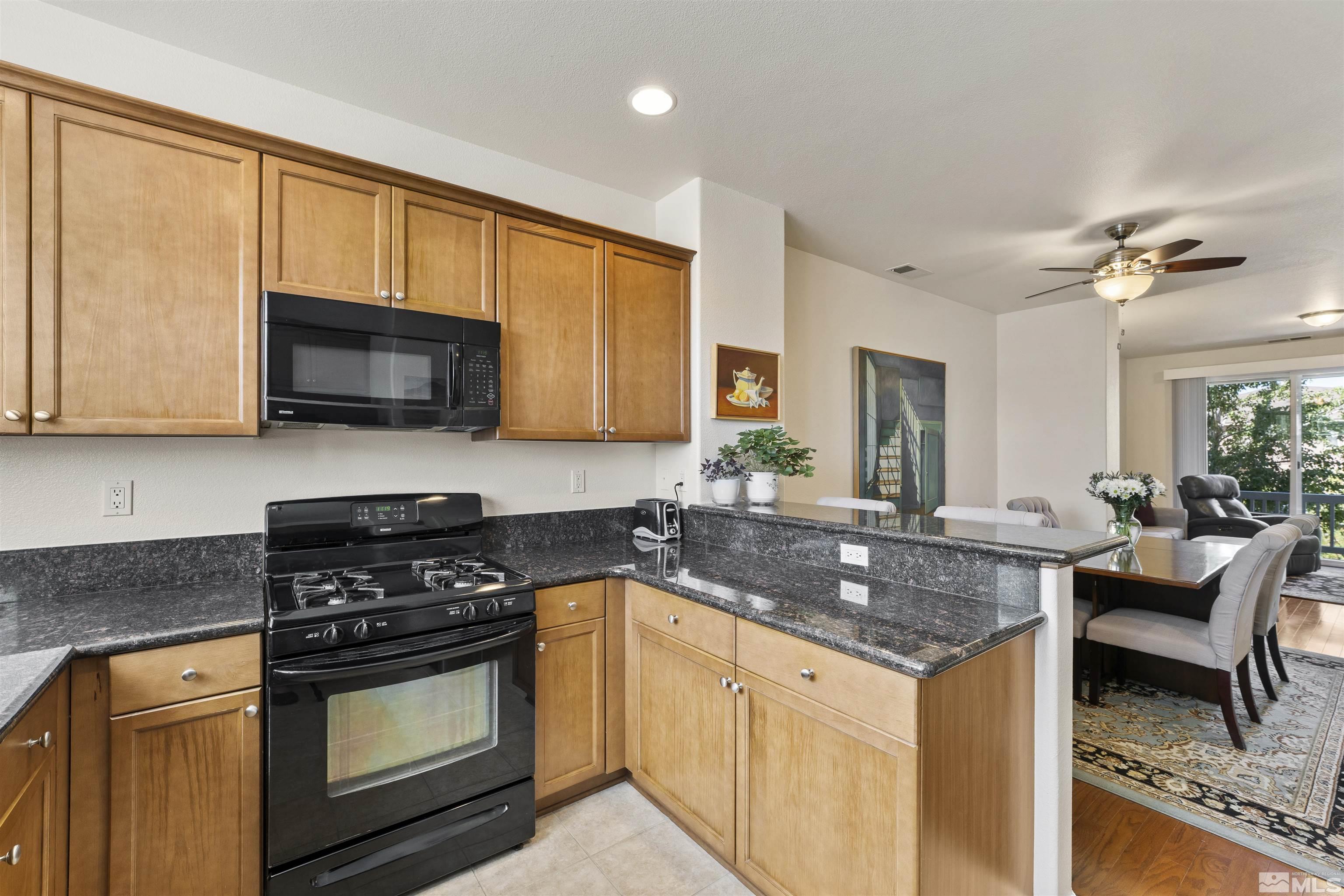 2212 Grosvenor Reno, NV 89509 - Photo 19 of 36 a kitchen with granite countertop a stove sink and microwave