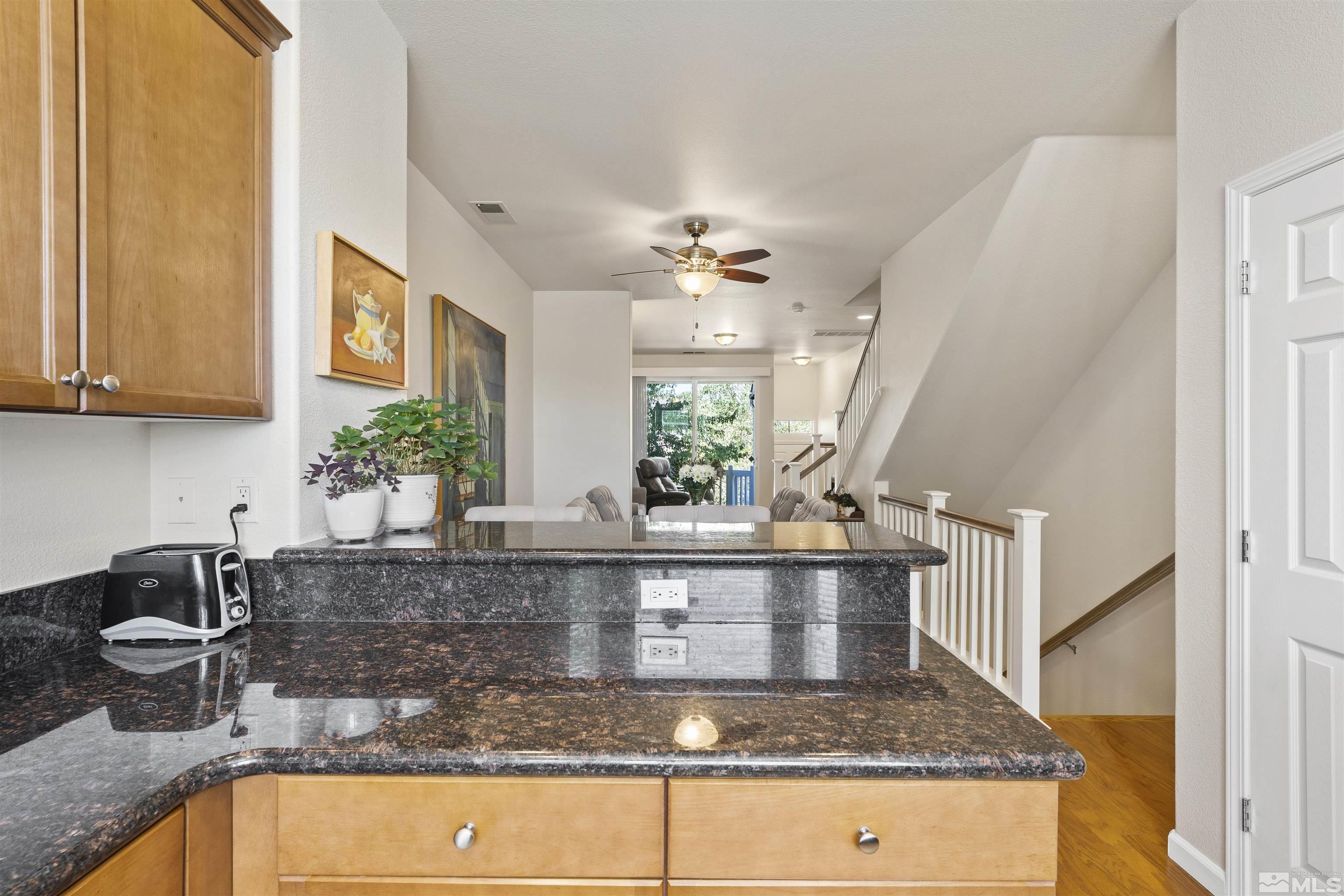 2212 Grosvenor Reno, NV 89509 - Photo 20 of 36 a kitchen with kitchen island granite countertop a sink a counter top space and cabinets