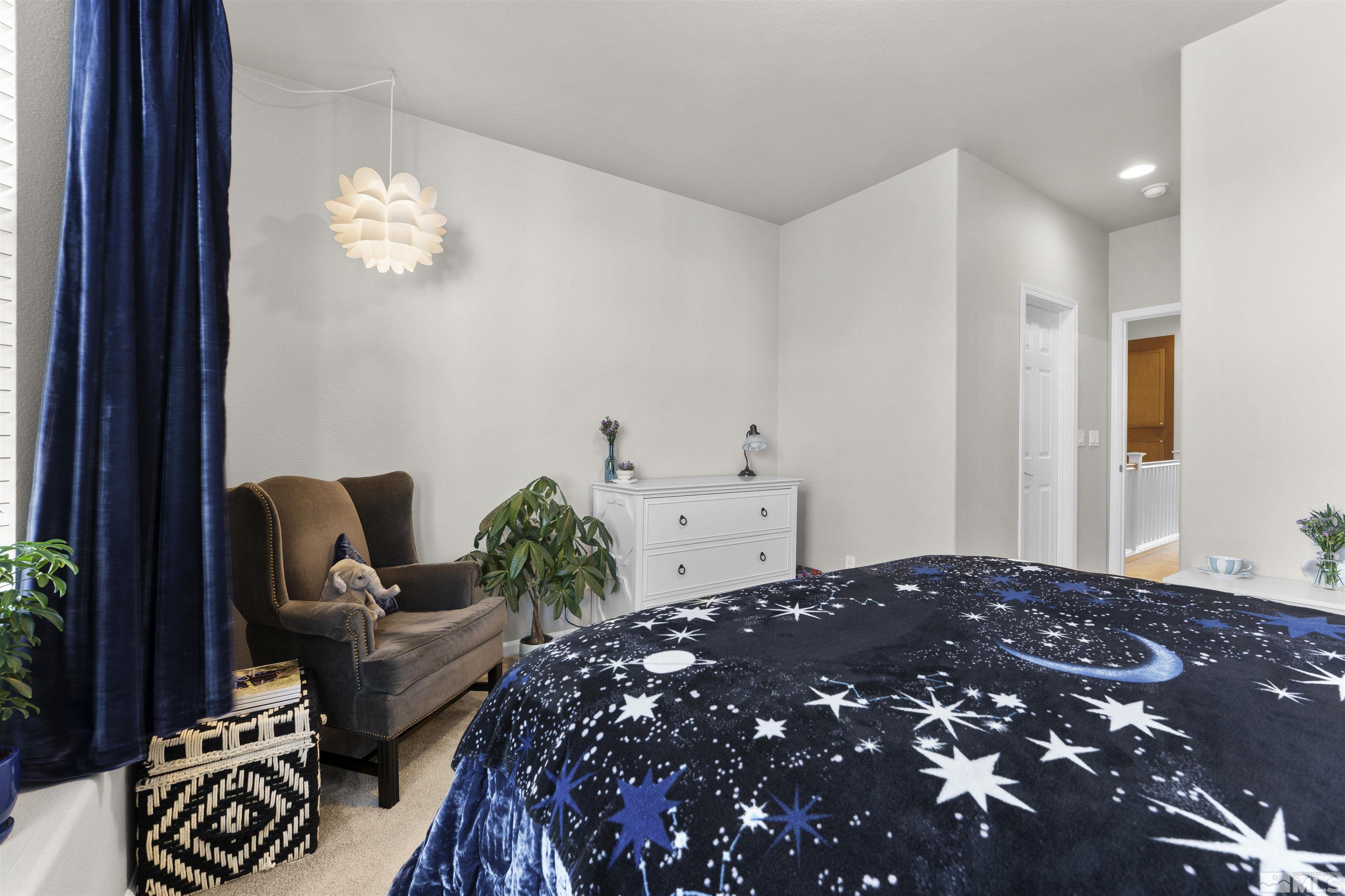 2212 Grosvenor Reno, NV 89509 - Photo 26 of 36 a large bed sitting in a bedroom next to a window and chair