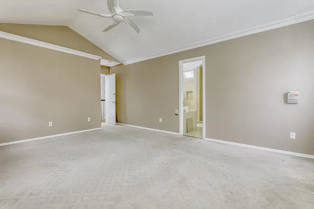 a view of an empty room and a ceiling fan