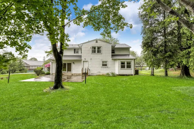 a front view of a house with a garden