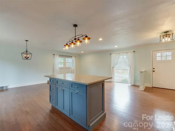 a view of a kitchen cabinets and wooden floor