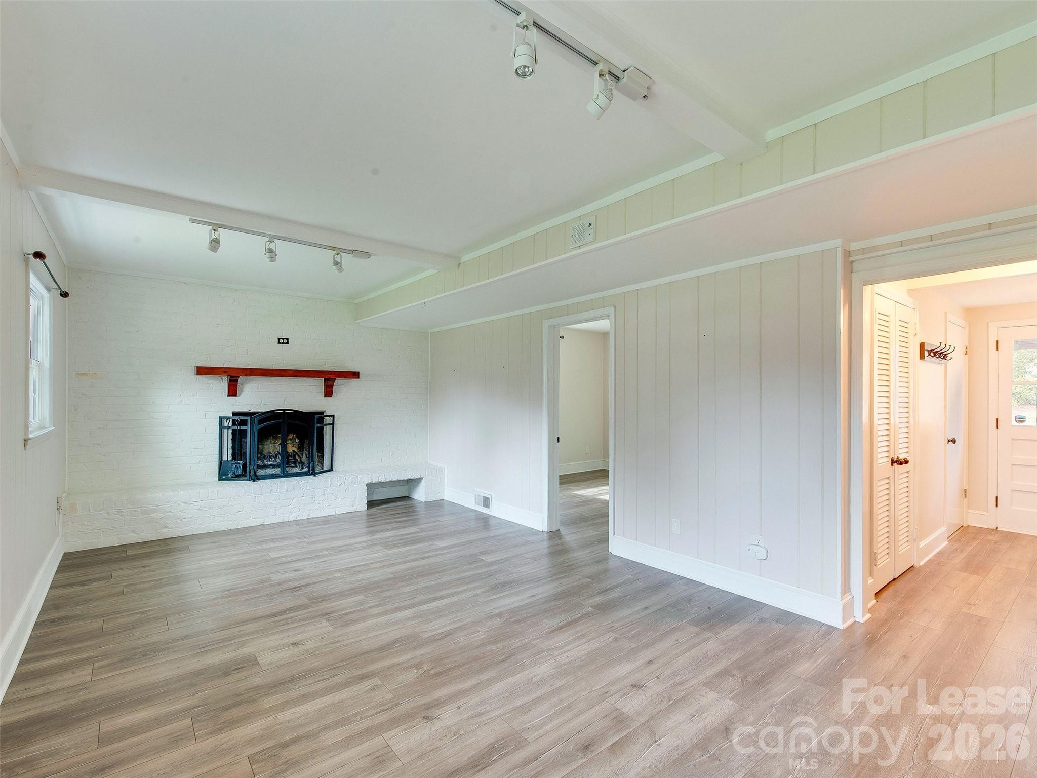 7026 Morganford Road Charlotte, NC 28211 - Photo 20 of 48 a view of an empty room with a fireplace and a window