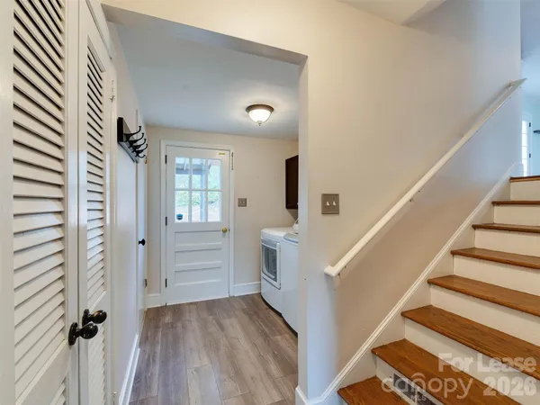 a view of entryway with furniture and wooden floor