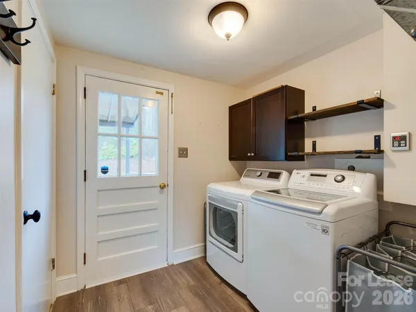 a view of washer and dryer with kitchen view