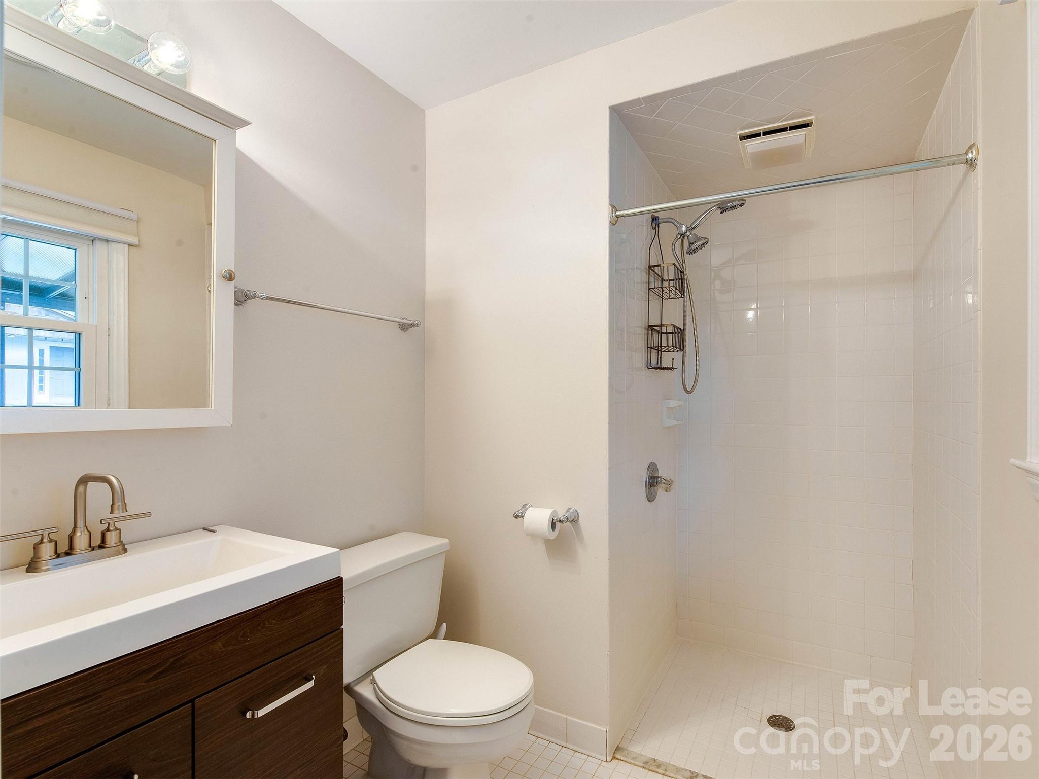 7026 Morganford Road Charlotte, NC 28211 - Photo 25 of 48 a bathroom with a sink a toilet and shower