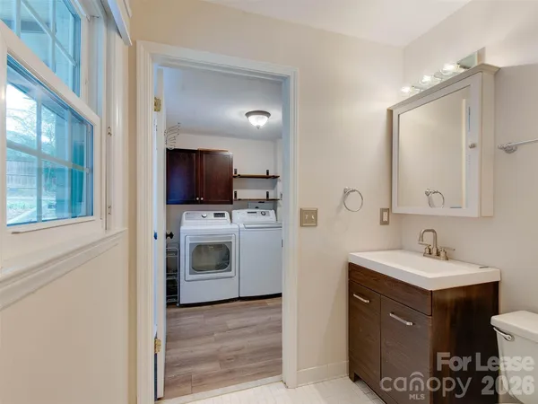 a bathroom with a sink toilet and mirror