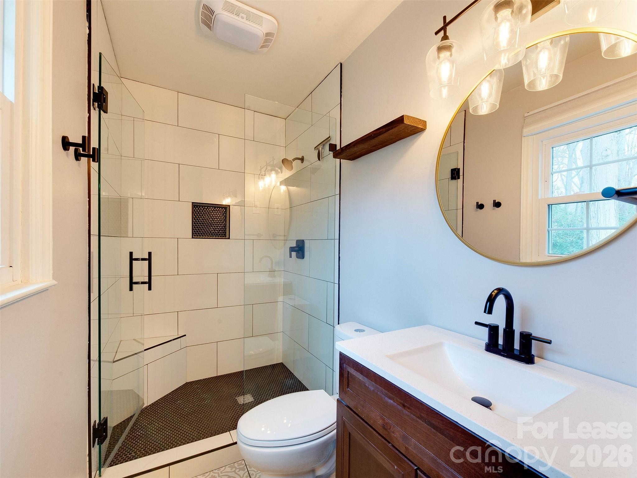 7026 Morganford Road Charlotte, NC 28211 - Photo 33 of 48 a bathroom with a sink a toilet and shower