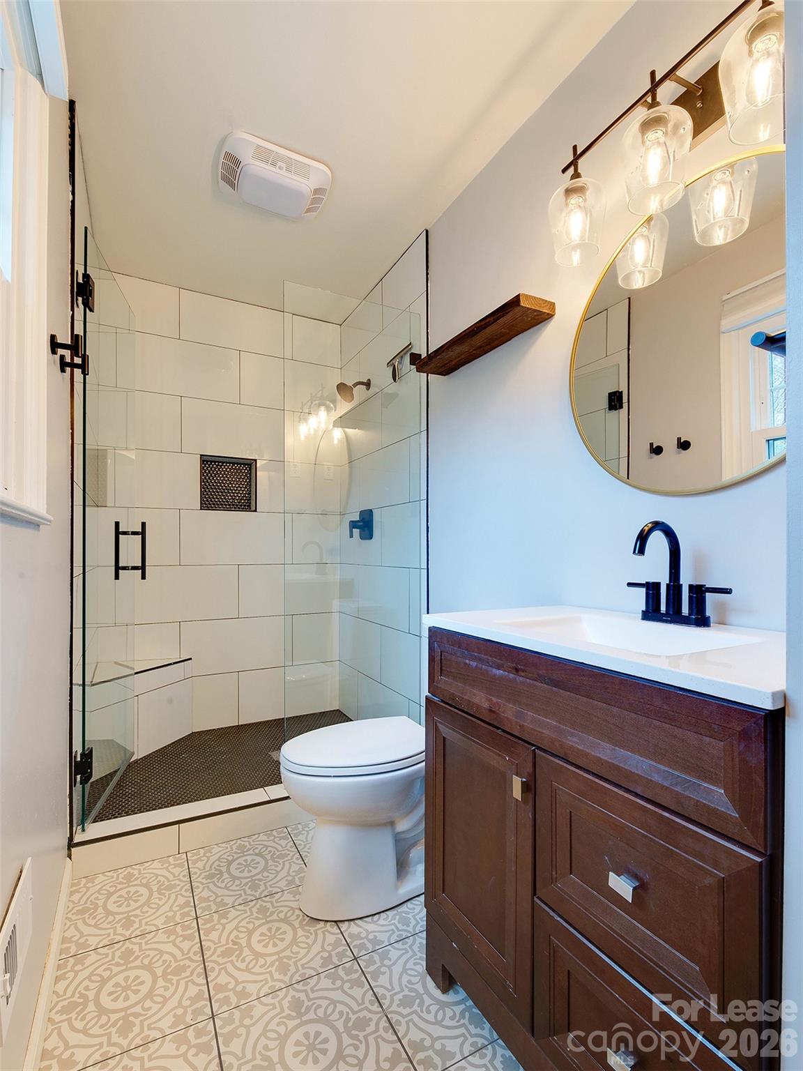 7026 Morganford Road Charlotte, NC 28211 - Photo 34 of 48 a bathroom with a sink a toilet and shower