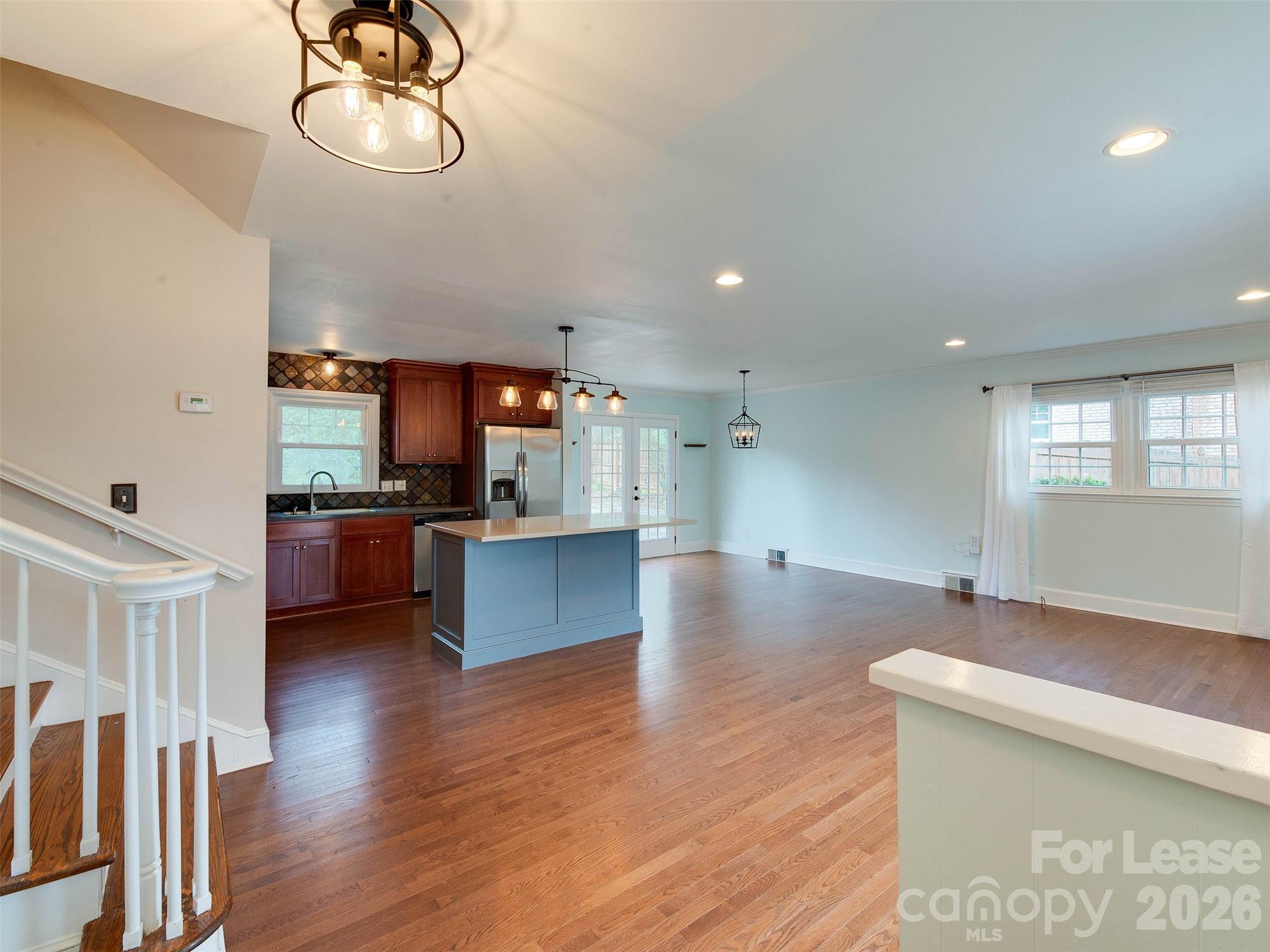 7026 Morganford Road Charlotte, NC 28211 - Photo 5 of 48 a kitchen with stainless steel appliances kitchen island a large counter top and a wooden floors