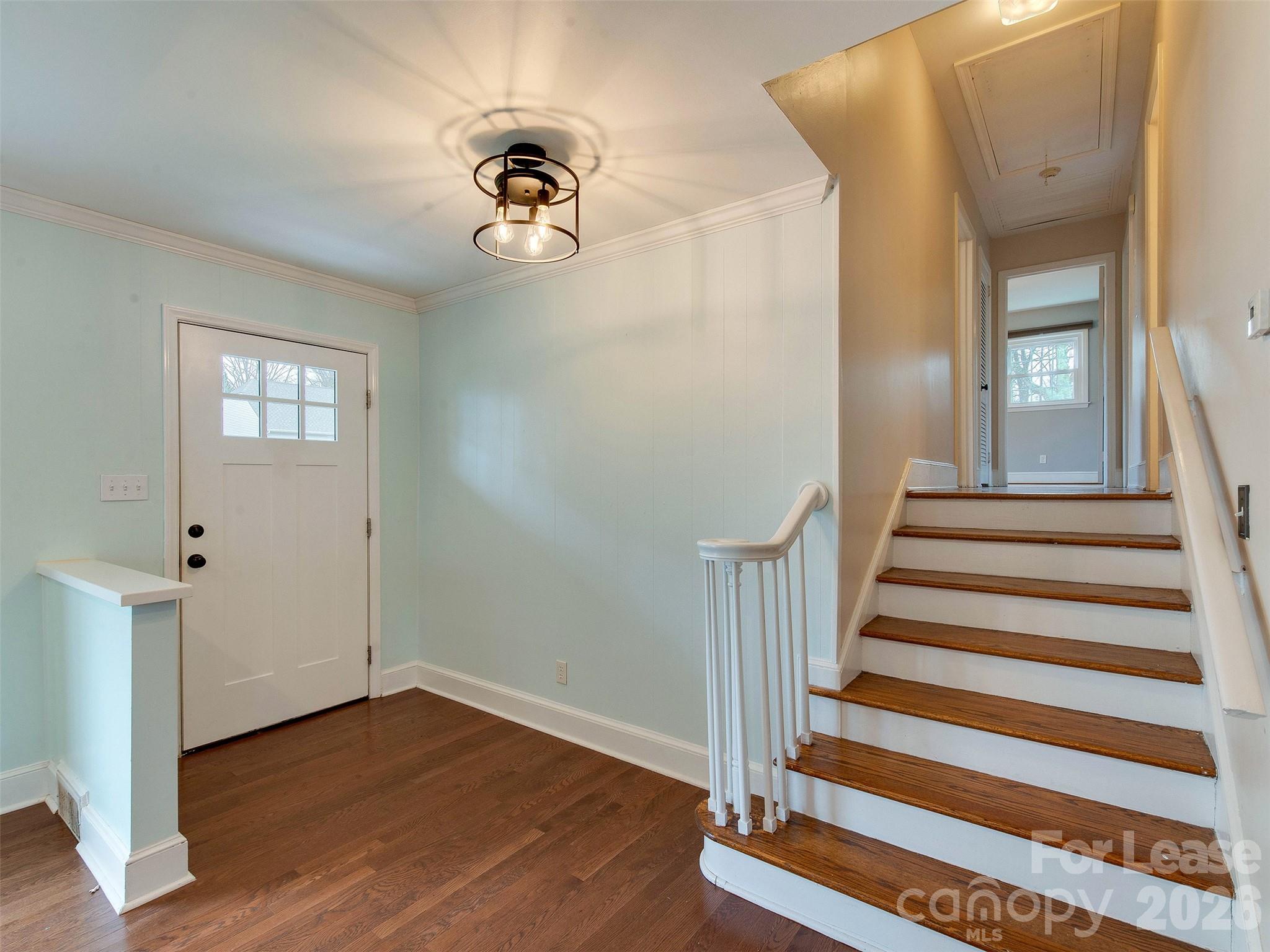 7026 Morganford Road Charlotte, NC 28211 - Photo 7 of 48 a view of a hallway with wooden floor and staircase