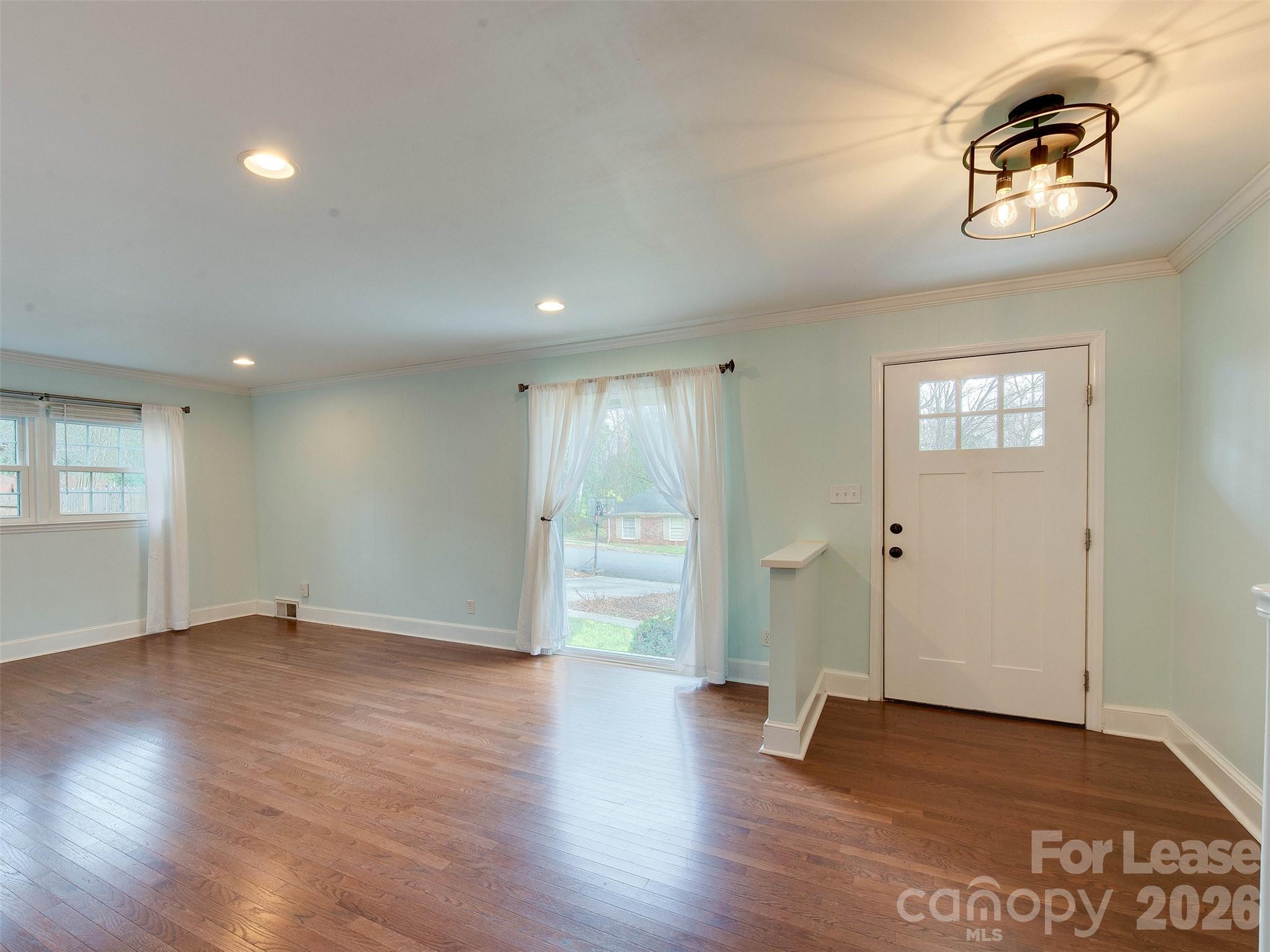 7026 Morganford Road Charlotte, NC 28211 - Photo 8 of 48 an empty room with wooden floor and windows