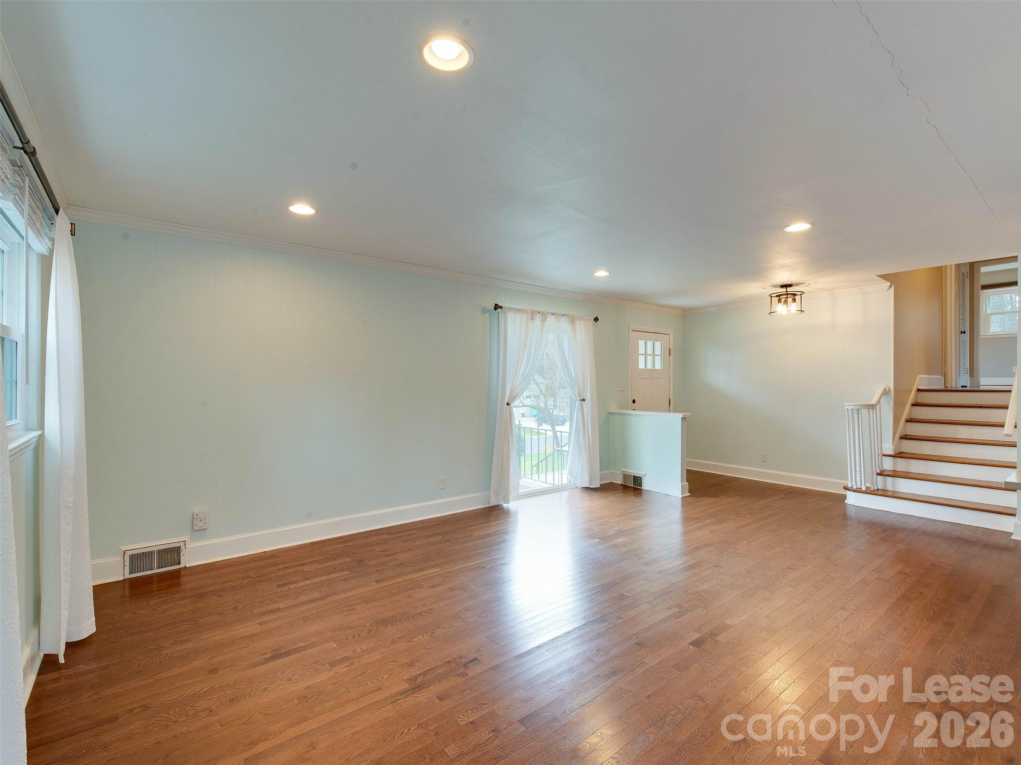 7026 Morganford Road Charlotte, NC 28211 - Photo 9 of 48 a view of an empty room with wooden floor and a window