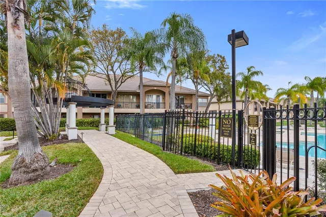 a front view of a house with a garden and yard