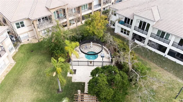 an aerial view of a residential apartment building with a yard