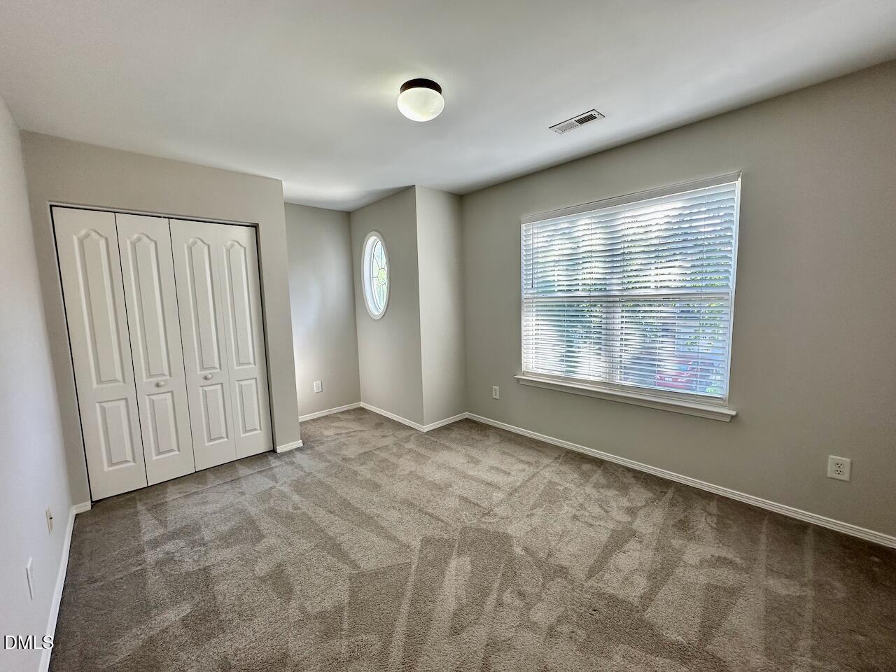 8208 Stone Cellar Drive Raleigh, NC 27613 - Photo 25 of 34 an empty room with windows