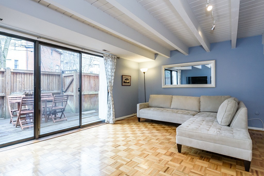120 Beaconsfield Road, Unit T6 Brookline, MA 02445 - Photo 6 of 14 a living room with furniture and a flat screen tv