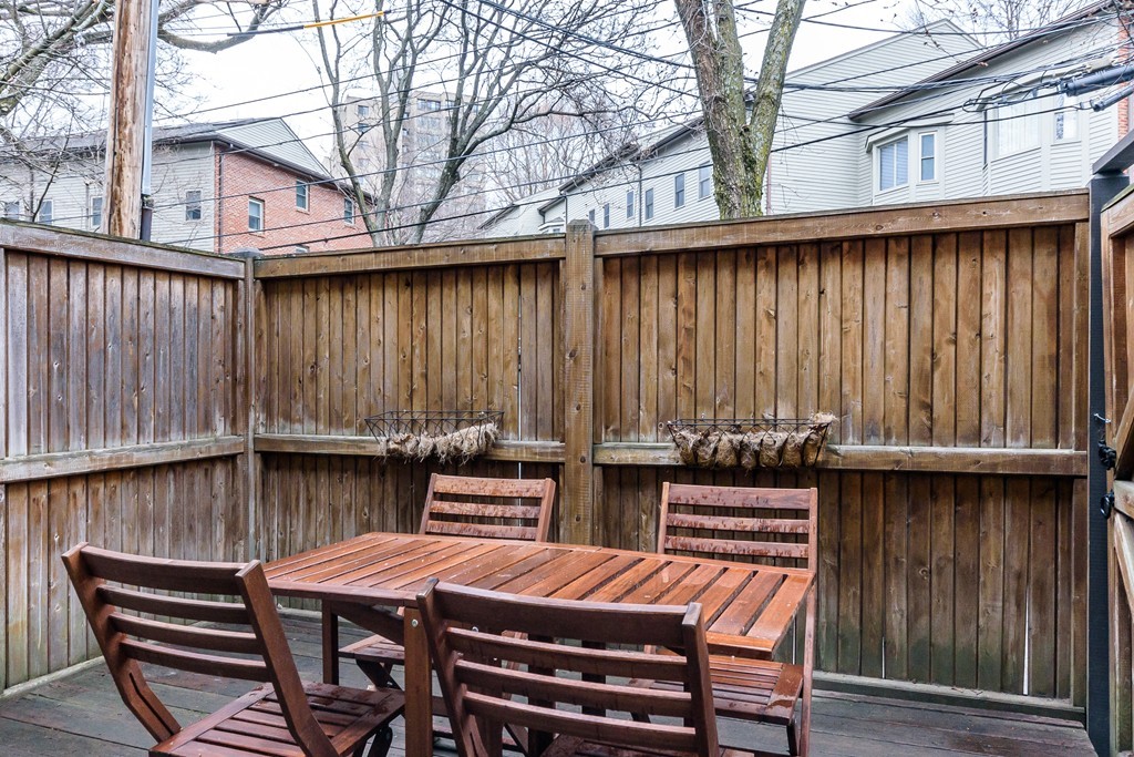 120 Beaconsfield Road, Unit T6 Brookline, MA 02445 - Photo 8 of 14 a view of a chairs and table on the wooden roof deck