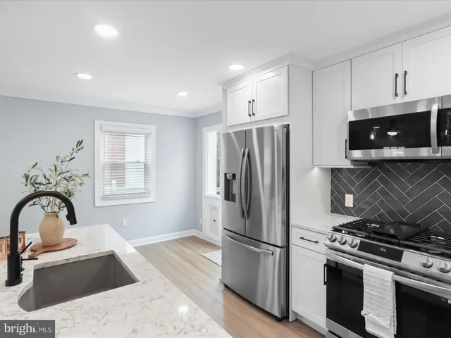 a kitchen with a refrigerator stove and sink