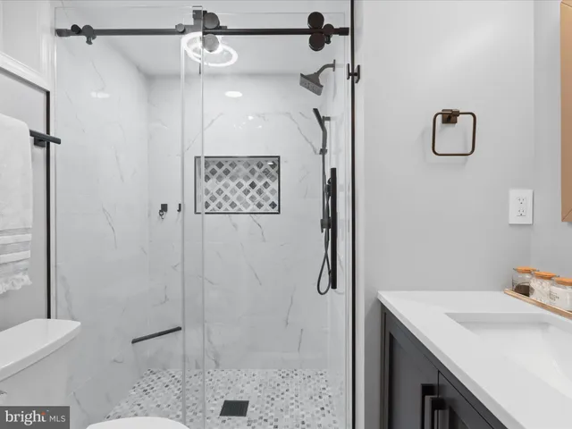 a bathroom with a sink toilet and shower