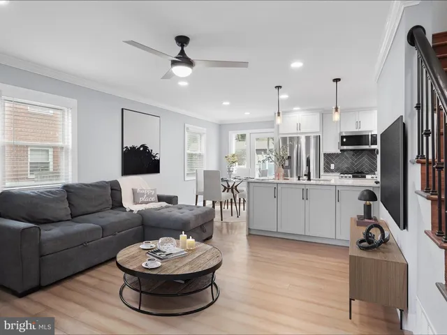 a living room with furniture and kitchen view