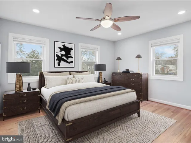 a bedroom with bed and a painting on the wall