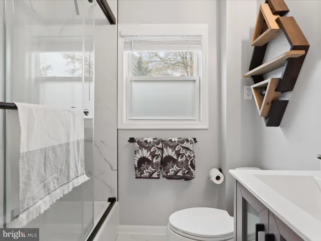 a bathroom with a toilet and a shower curtain