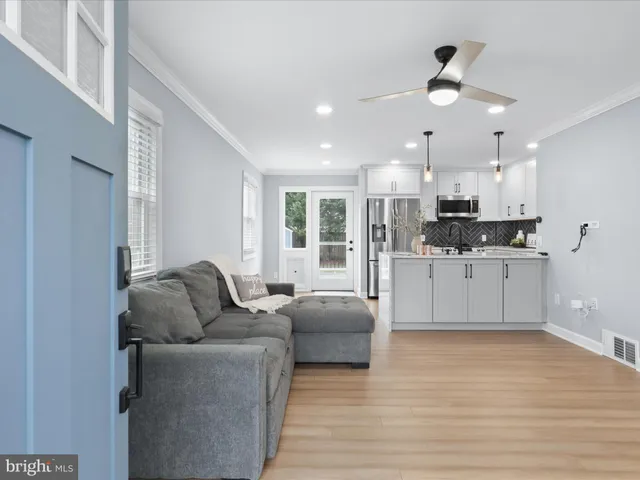 a living room with furniture and kitchen view