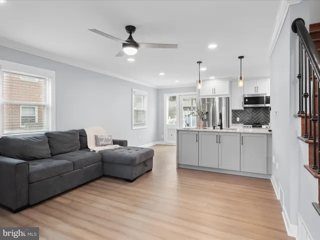 a living room with furniture and kitchen view