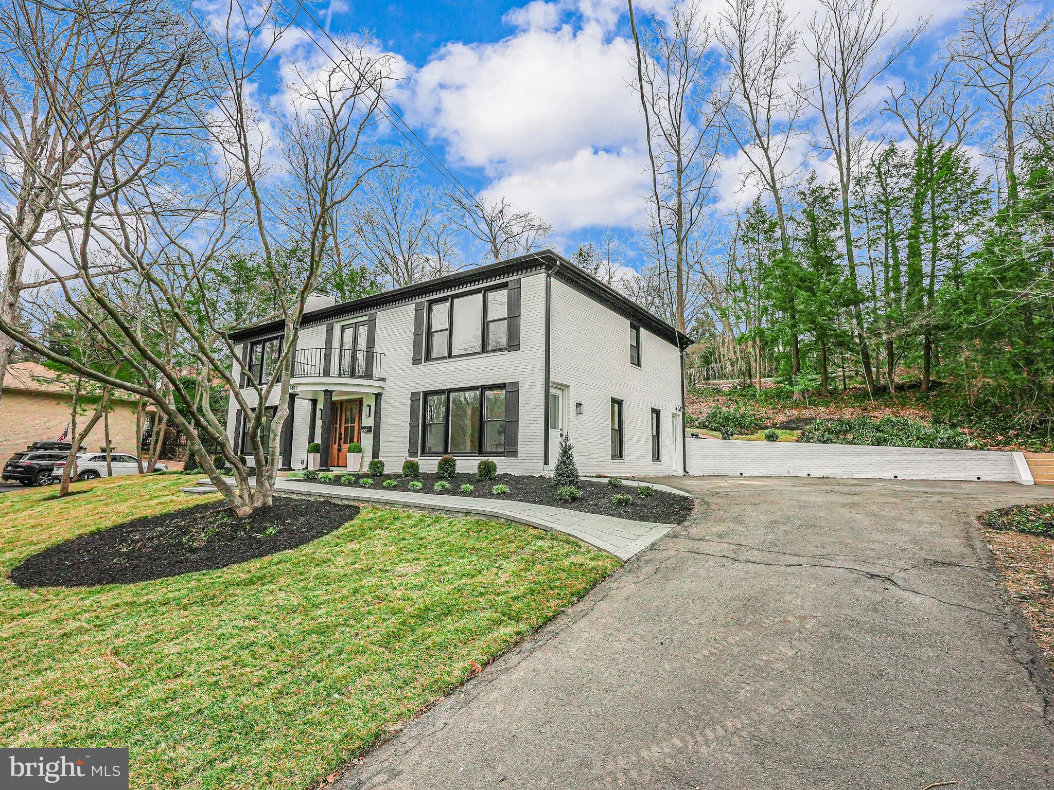 7401 Fort Hunt Road Alexandria, VA 22307 - Photo 3 of 56 a view of a white house with a yard and large trees